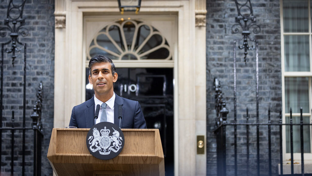 Rishi Sunak stands at a podium in front of No. 10 Downing St for his first speech as Prime Minister